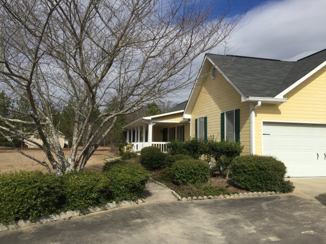 5016 Hartley Bridge Road Macon, GA 31216 - Photo 27 of 27 a front view of a house with a yard