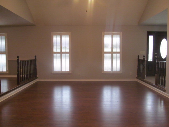 5016 Hartley Bridge Road Macon, GA 31216 - Photo 4 of 27 a view of an empty room with wooden floor and a window