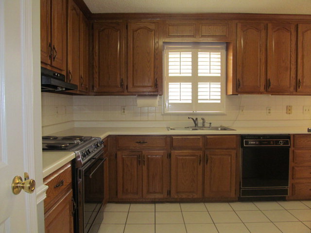 5016 Hartley Bridge Road Macon, GA 31216 - Photo 8 of 27 a kitchen with granite countertop a sink stove and cabinets