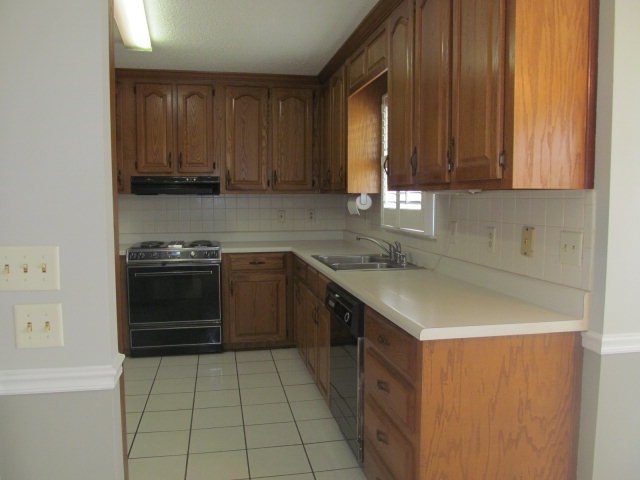 5016 Hartley Bridge Road Macon, GA 31216 - Photo 9 of 27 a kitchen with a cabinets and appliances