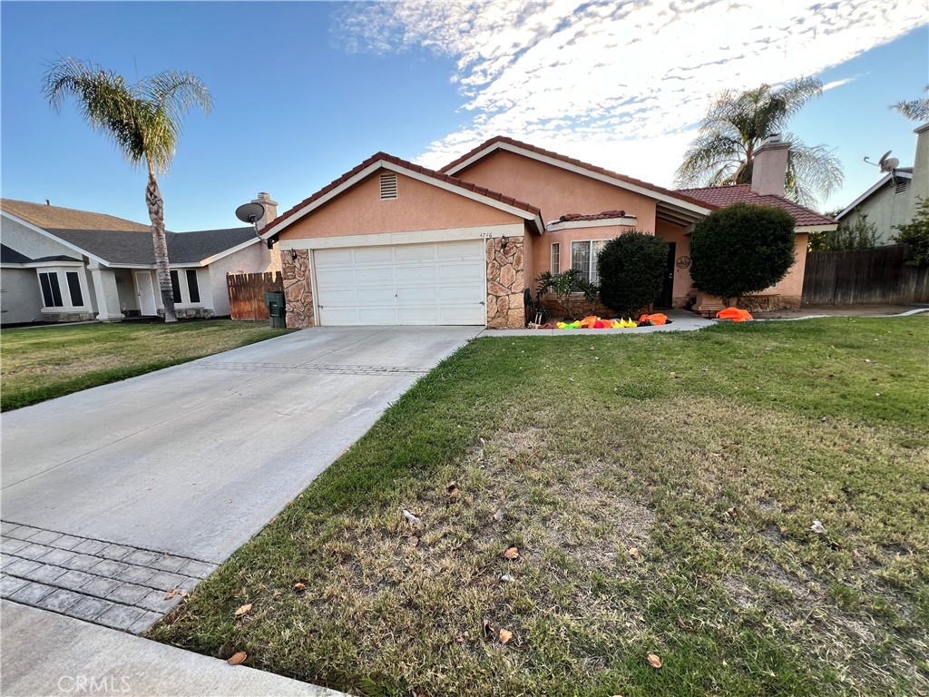 4746 Mango Court Riverside, CA 92504 - Photo 1 of 1 a front view of a house with a garden and yard