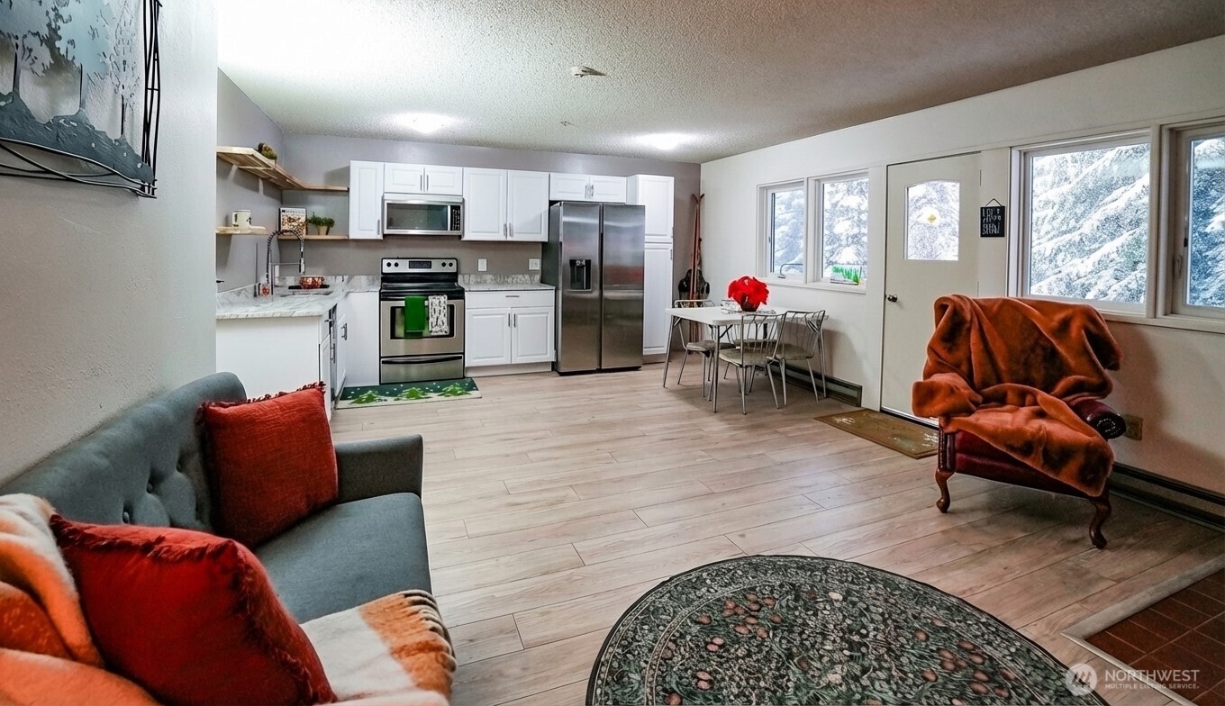 220 Tanner Way, Unit 206 Snoqualmie Pass, WA 98068 - Photo 11 of 37 a living room with furniture and a window