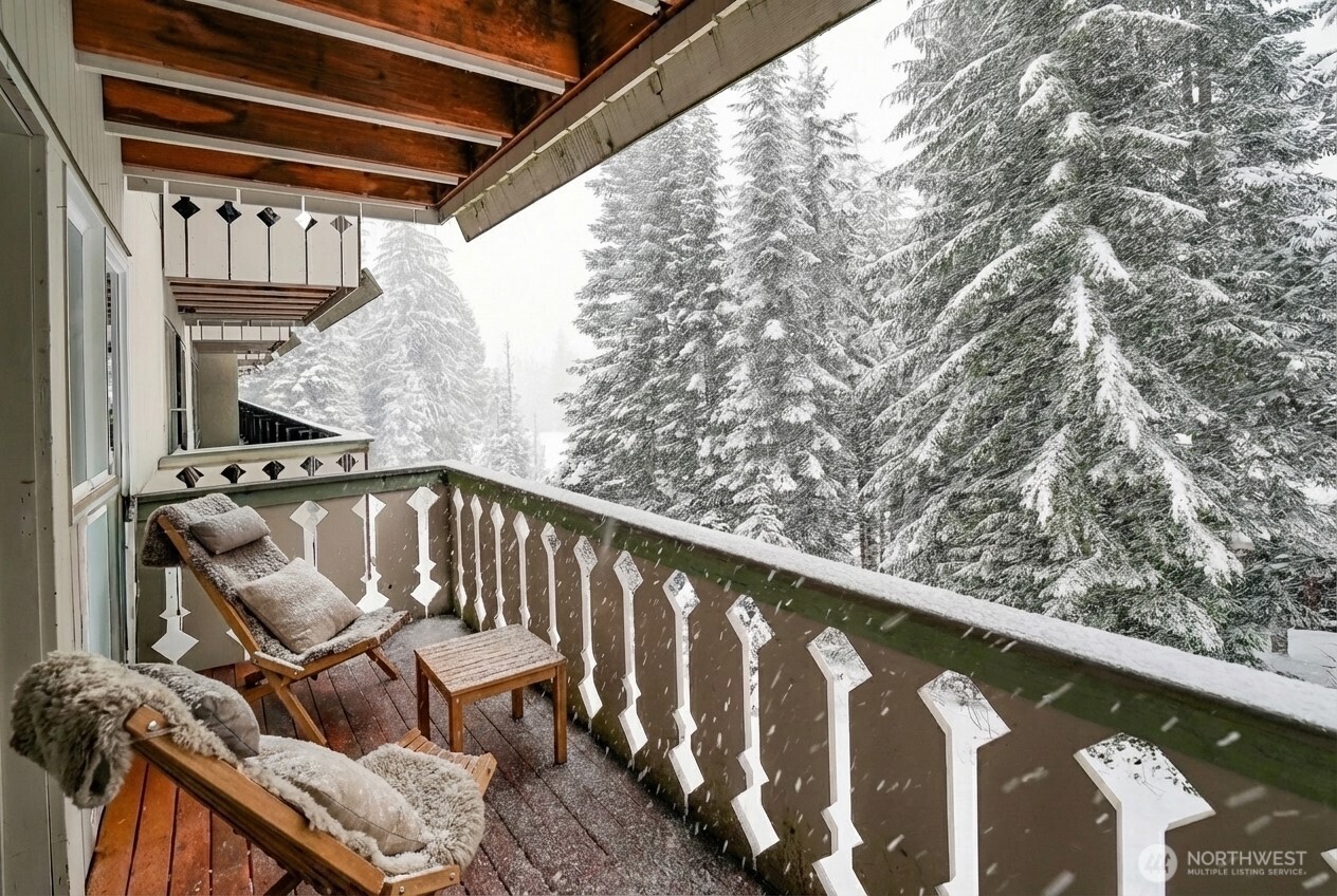 220 Tanner Way, Unit 206 Snoqualmie Pass, WA 98068 - Photo 14 of 37 a balcony with wooden floor stairs and furniture