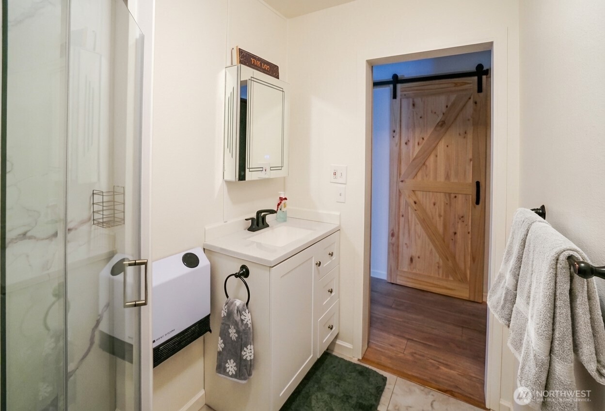 220 Tanner Way, Unit 206 Snoqualmie Pass, WA 98068 - Photo 18 of 37 a bathroom with a sink a toilet and shower