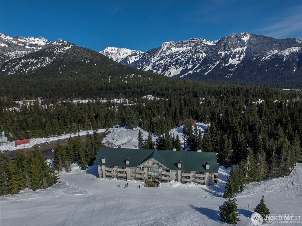 220 Tanner Way, Unit 206 Snoqualmie Pass, WA 98068 - Photo 24 of 37 a view of patio with a table under an umbrella