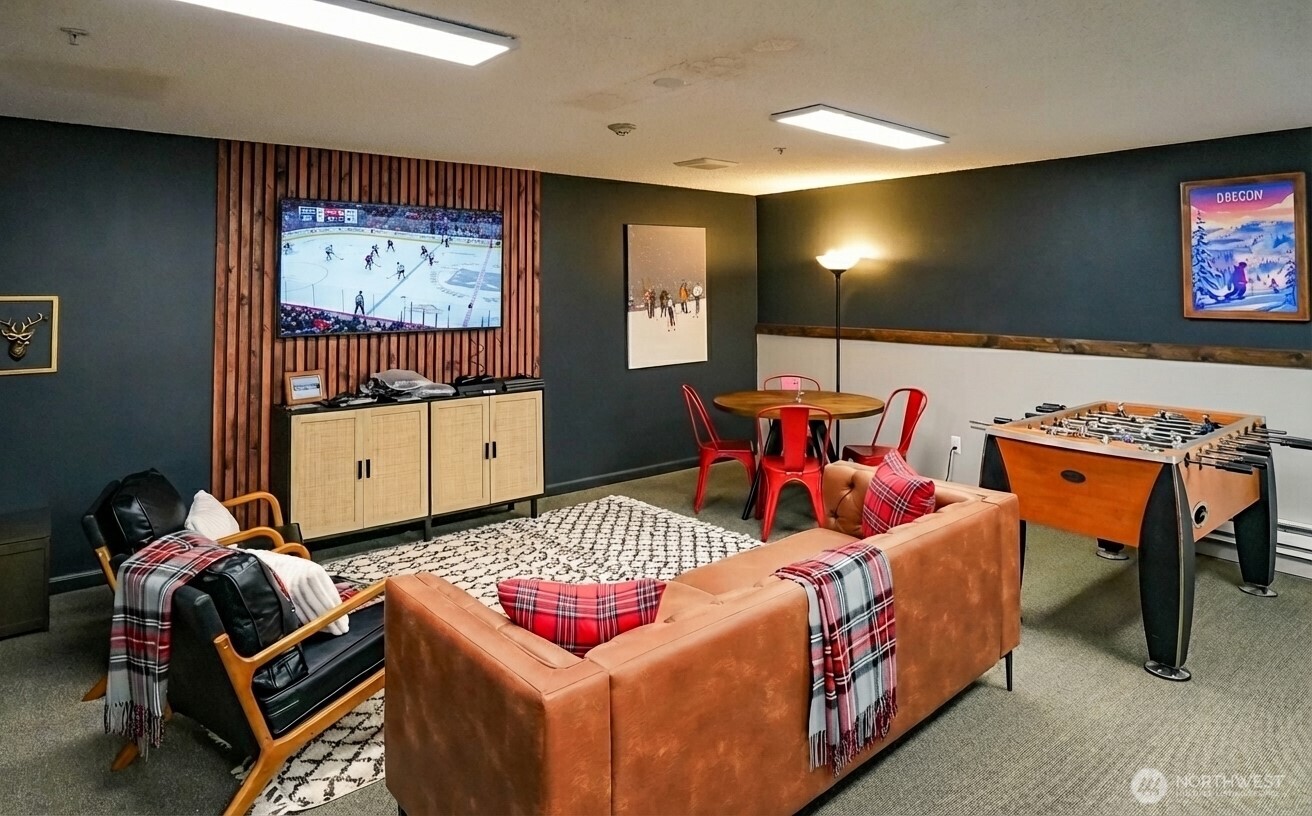 220 Tanner Way, Unit 206 Snoqualmie Pass, WA 98068 - Photo 27 of 37 a bedroom with furniture and a flat screen tv