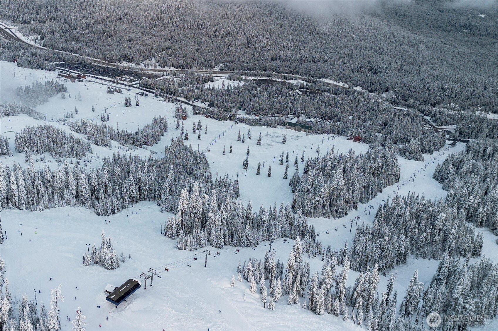 220 Tanner Way, Unit 206 Snoqualmie Pass, WA 98068 - Photo 34 of 37 a view of a dry yard covered with snow in the background