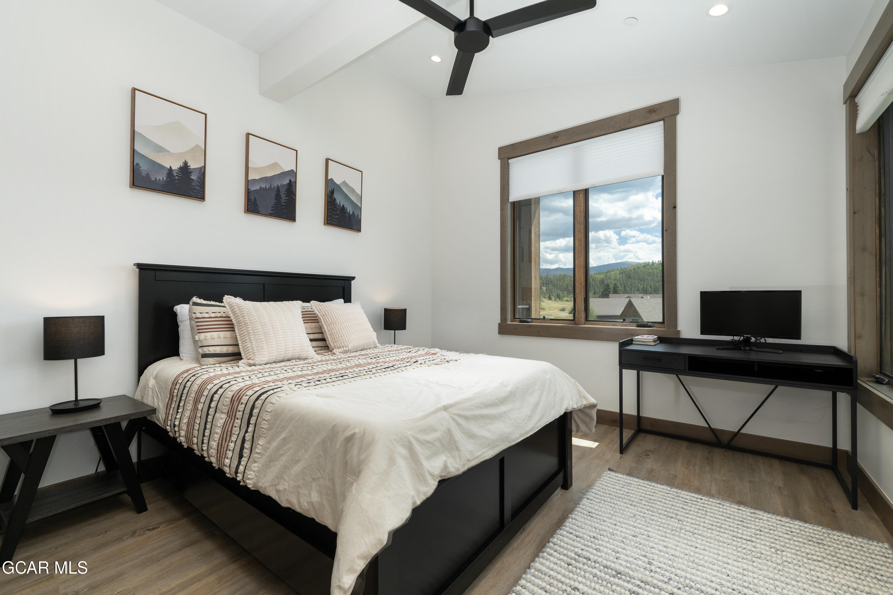 96 Meadow Trail, Unit G304 Fraser, CO 80442 - Photo 25 of 37 a bedroom with a bed a desk and chair