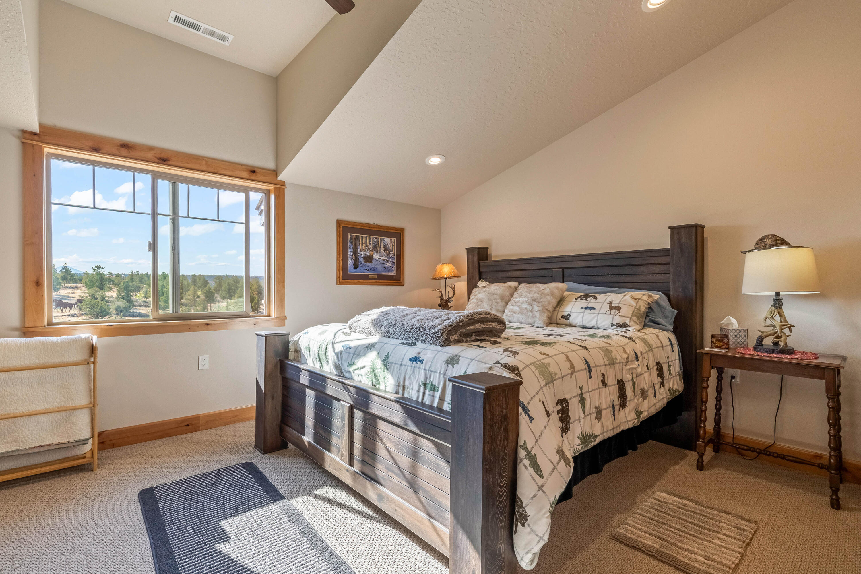 70030 Northwest Hunt Road Sisters, OR 97759 - Photo 23 of 55 a bedroom with a large bed and a window