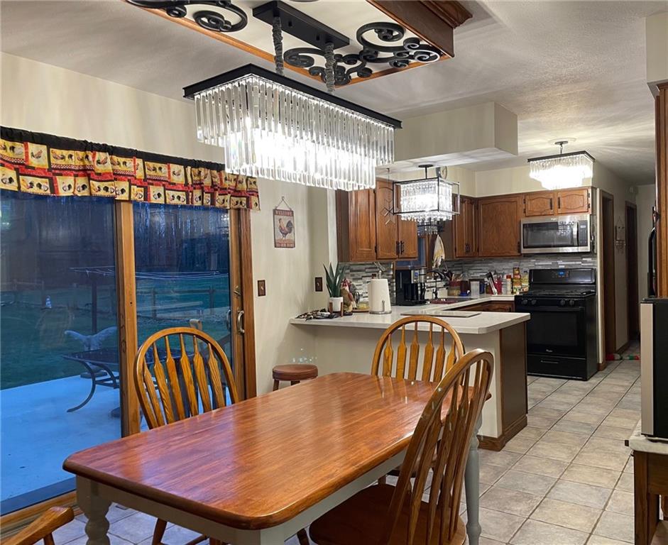 7950 Page Road Wattsburg, PA 16442 - Photo 3 of 21 a dining table with chairs and kitchen view