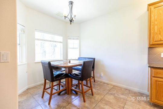 409 Acacia Street Ridgecrest, CA 93555 - Photo 14 of 34 a view of a dining room with furniture and a window