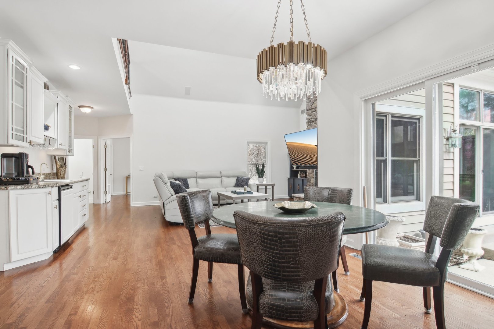 1005 Bridle Lane Cary, IL 60013 - Photo 19 of 64 a dining room with wooden floor a chandelier a wooden table and chairs