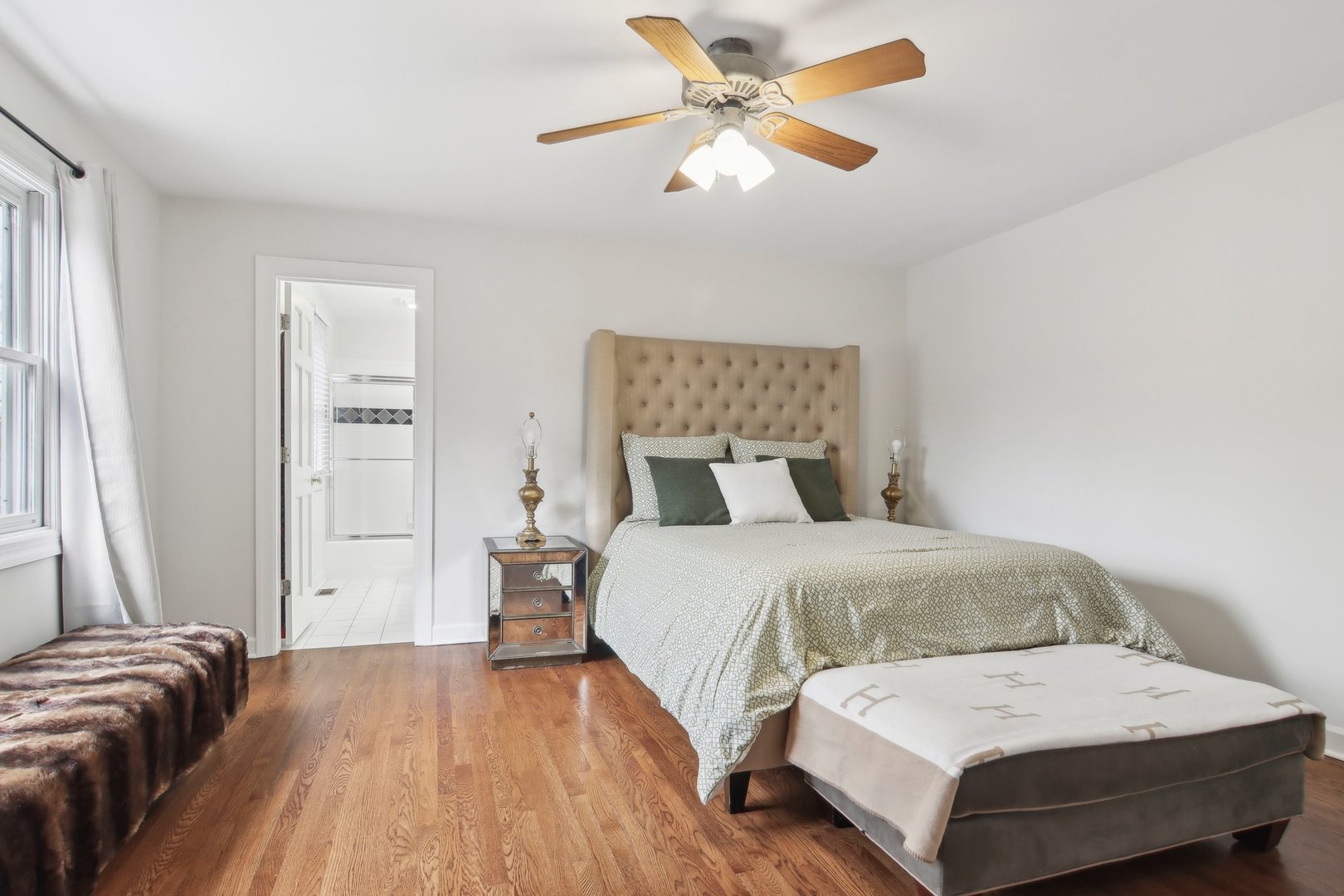 1005 Bridle Lane Cary, IL 60013 - Photo 33 of 64 a bedroom with a bed and a chandelier