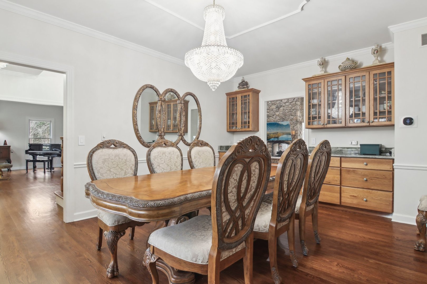 1005 Bridle Lane Cary, IL 60013 - Photo 6 of 64 a dining room with furniture a chandelier and wooden floor
