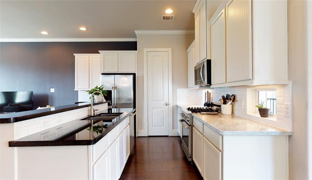 2724 Rutland Street Houston, TX 77008 - Photo 12 of 29 a kitchen with a sink stove top oven and refrigerator