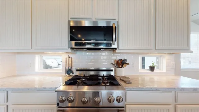 a kitchen with a stove and a microwave
