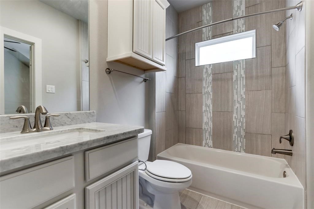 2724 Rutland Street Houston, TX 77008 - Photo 17 of 29 a bathroom with a granite countertop sink toilet and shower
