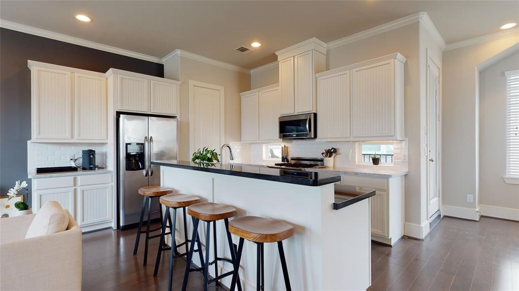 2724 Rutland Street Houston, TX 77008 - Photo 2 of 29 a kitchen with white cabinets and stainless steel appliances