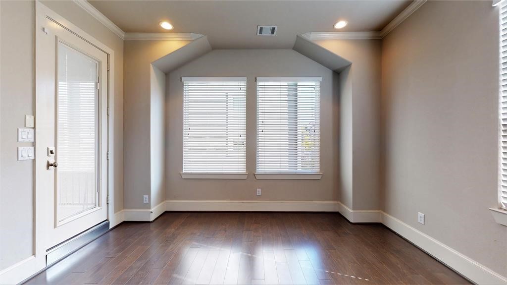 2724 Rutland Street Houston, TX 77008 - Photo 7 of 29 an empty room with wooden floor and windows
