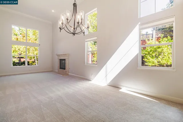 a view of an entryway with wooden floor windows and a chandelier