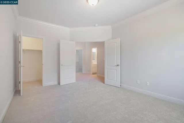 a view of an empty room with window and fire place