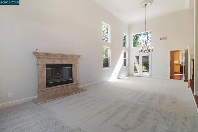 a view of a hallway with entryway and chandelier