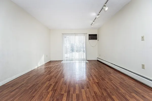 wooden floor in an empty room with a window