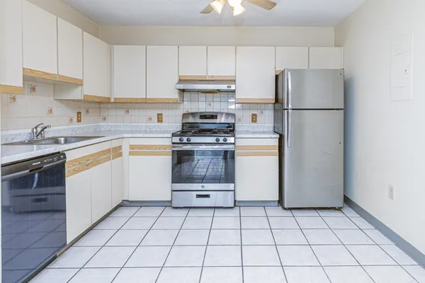 a kitchen with a stove a refrigerator and a sink