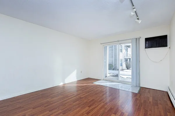 a view of wooden floor and windows in a room