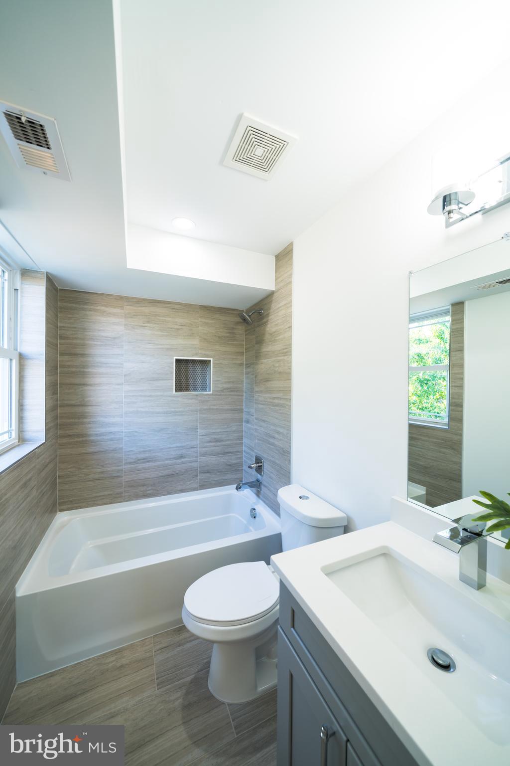 400 Newcomb Street Southeast, Unit 6 Washington, DC 20032 - Photo 22 of 29 a bathroom with a sink a toilet and bathtub
