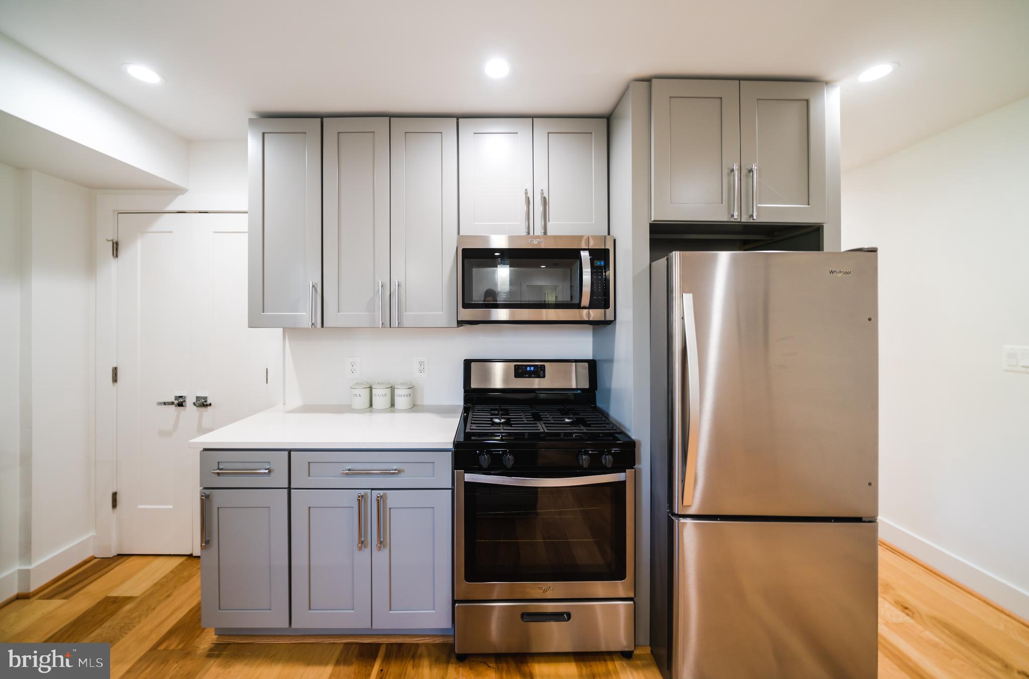 400 Newcomb Street Southeast, Unit 6 Washington, DC 20032 - Photo 9 of 29 a kitchen with stainless steel appliances a refrigerator stove and microwave