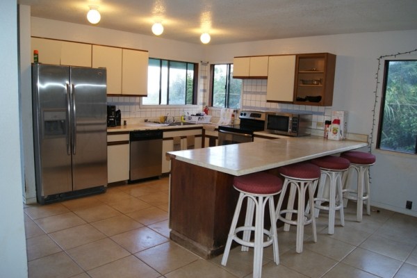 5609 Honua Road, Unit 1 Kapaa, HI 96746 - Photo 8 of 24 a kitchen with stainless steel appliances granite countertop a sink a stove a refrigerator a counter top space and appliances