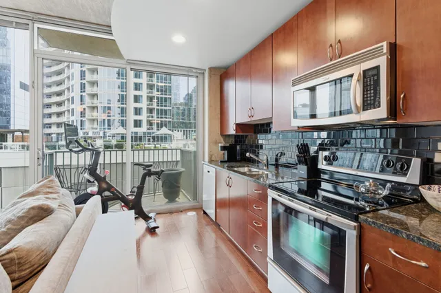 a kitchen with a stove a sink and cabinets
