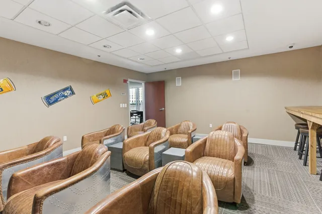 a building outdoor space with patio furniture and potted plants