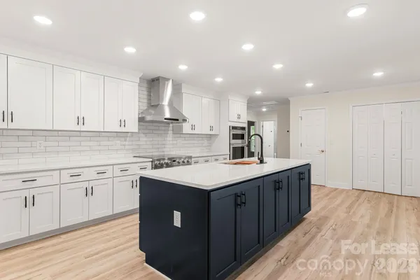 a kitchen with stainless steel appliances a sink and a refrigerator