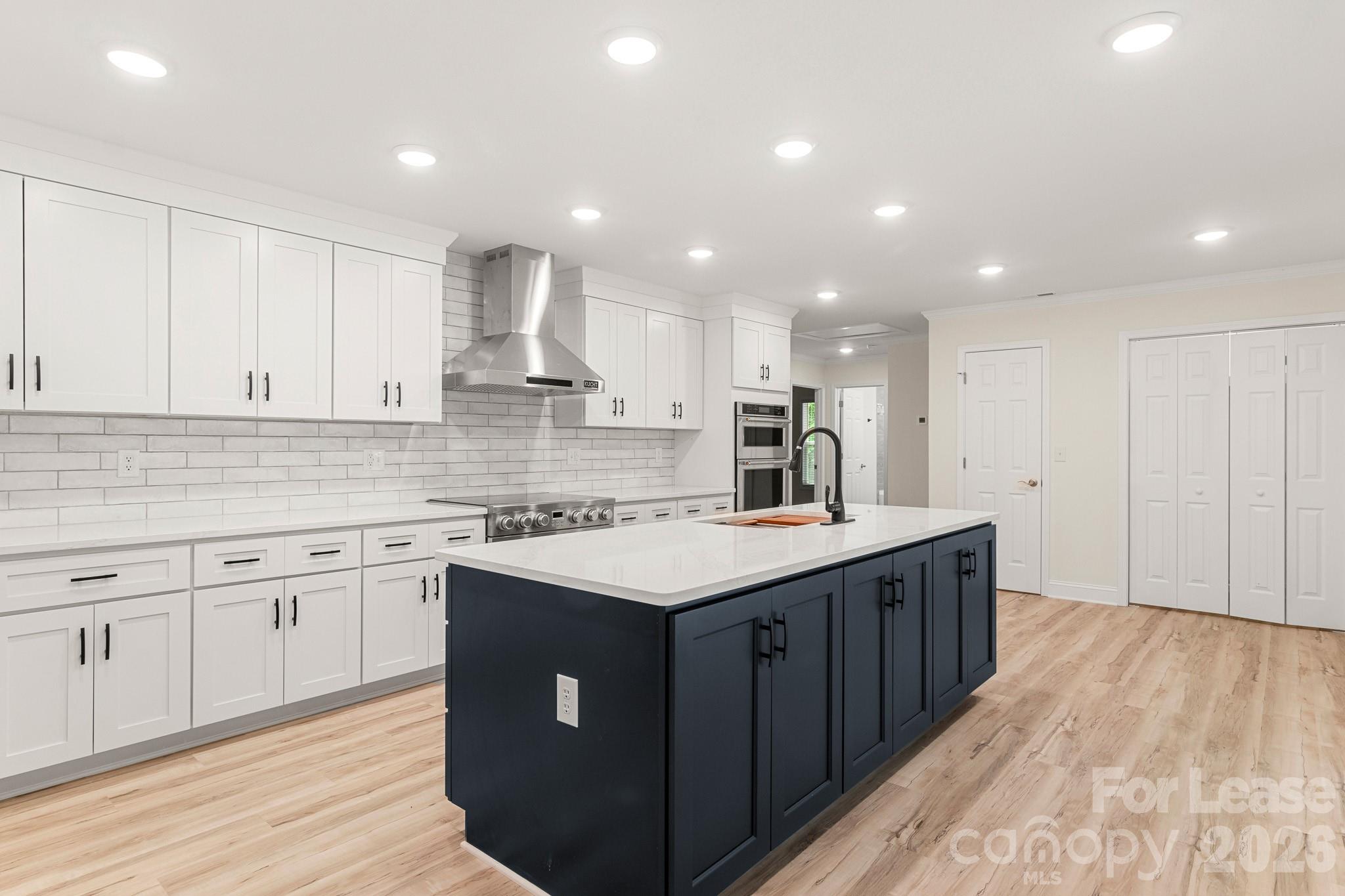116 Maple Grove Church Road Matthews, NC 28104 - Photo 12 of 41 a kitchen with kitchen island wooden cabinets and sink