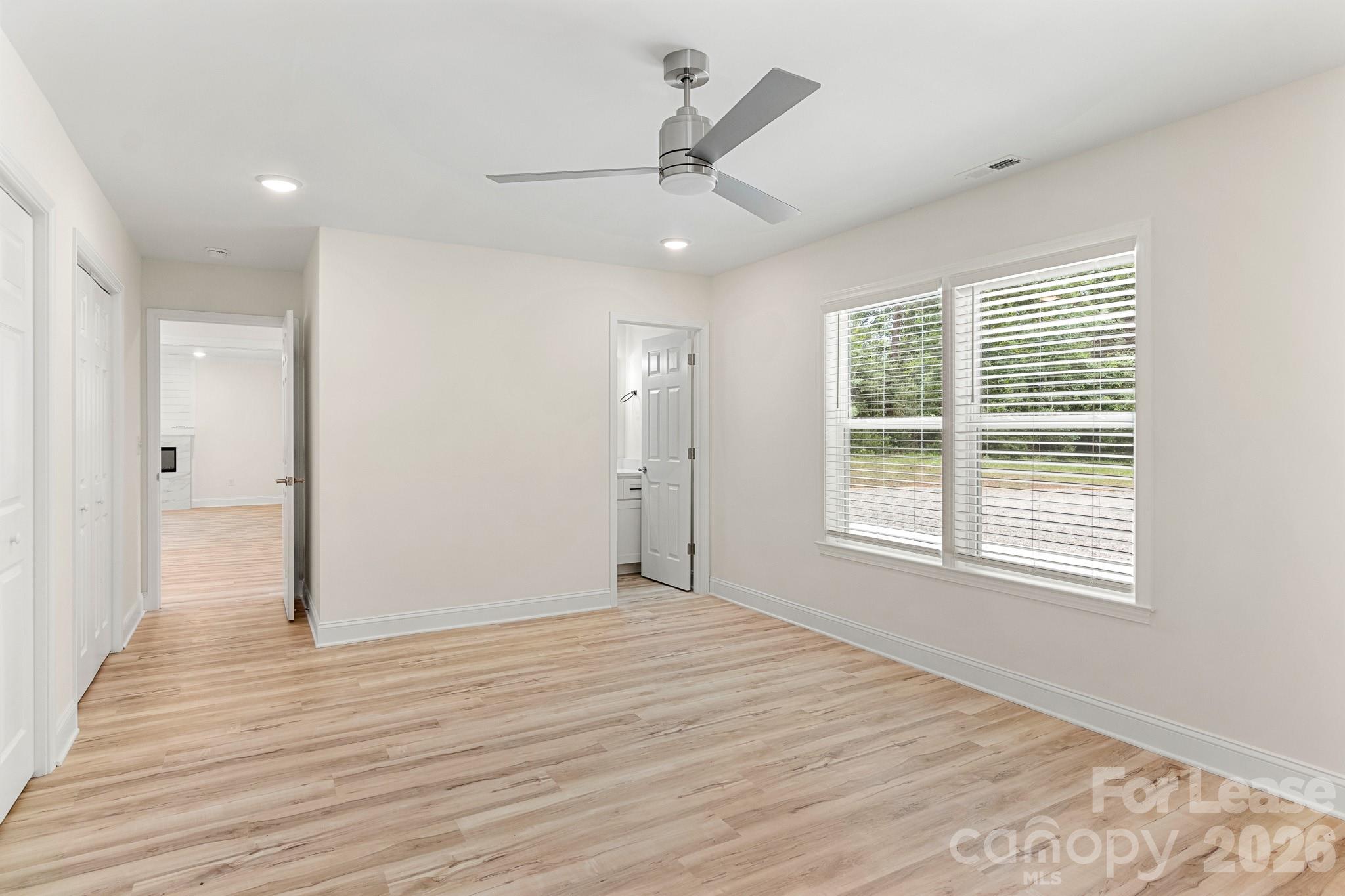 116 Maple Grove Church Road Matthews, NC 28104 - Photo 16 of 41 a view of an empty room with wooden floor and a window