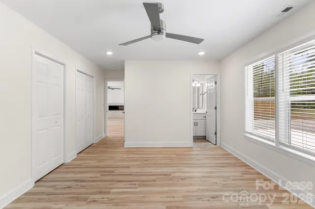 a bathroom with a sink a toilet a mirror and shower