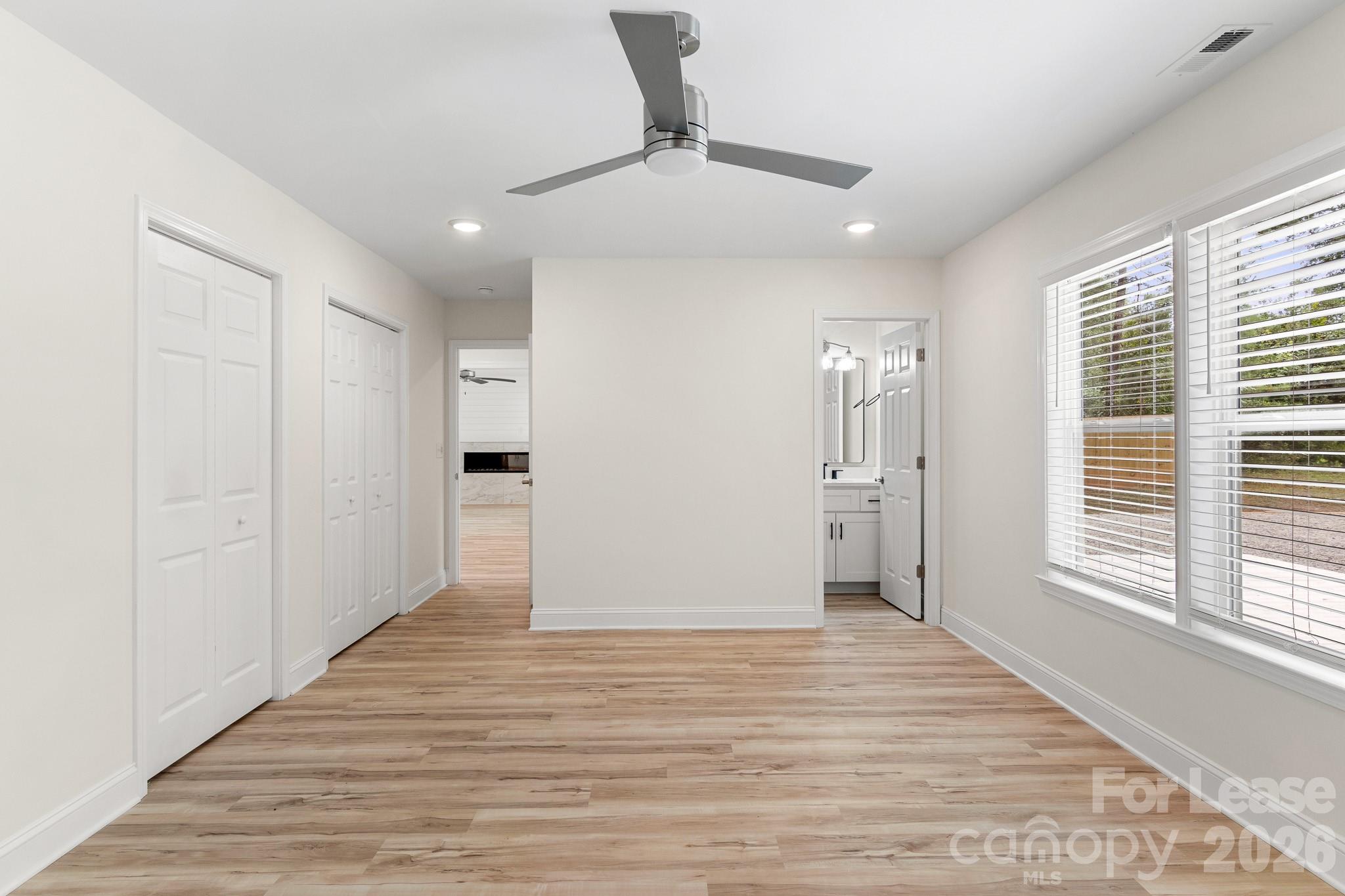 116 Maple Grove Church Road Matthews, NC 28104 - Photo 17 of 41 a view of an empty room with wooden floor and a window