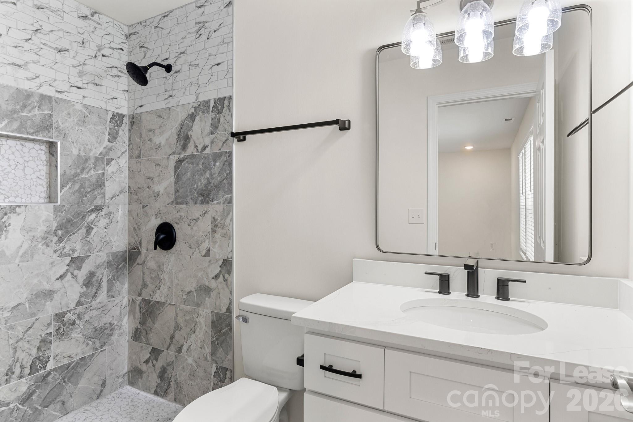 116 Maple Grove Church Road Matthews, NC 28104 - Photo 18 of 41 a bathroom with a sink a toilet a mirror and shower
