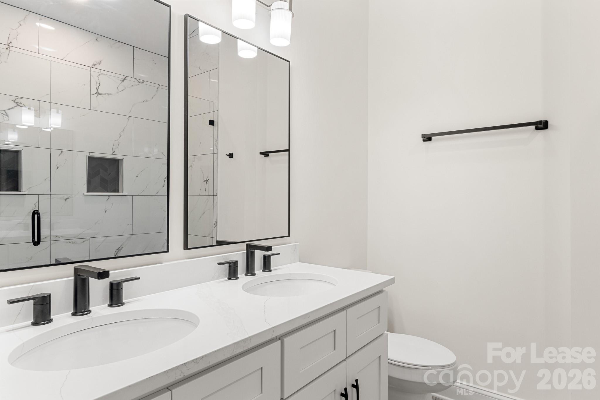 116 Maple Grove Church Road Matthews, NC 28104 - Photo 24 of 41 a bathroom with a sink toilet vanity and shower