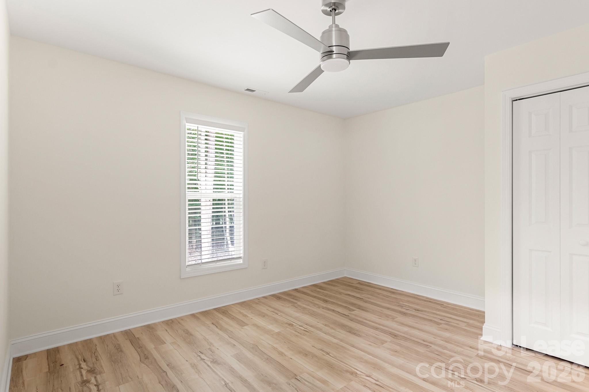 116 Maple Grove Church Road Matthews, NC 28104 - Photo 27 of 41 a view of empty room with wooden floor and fan