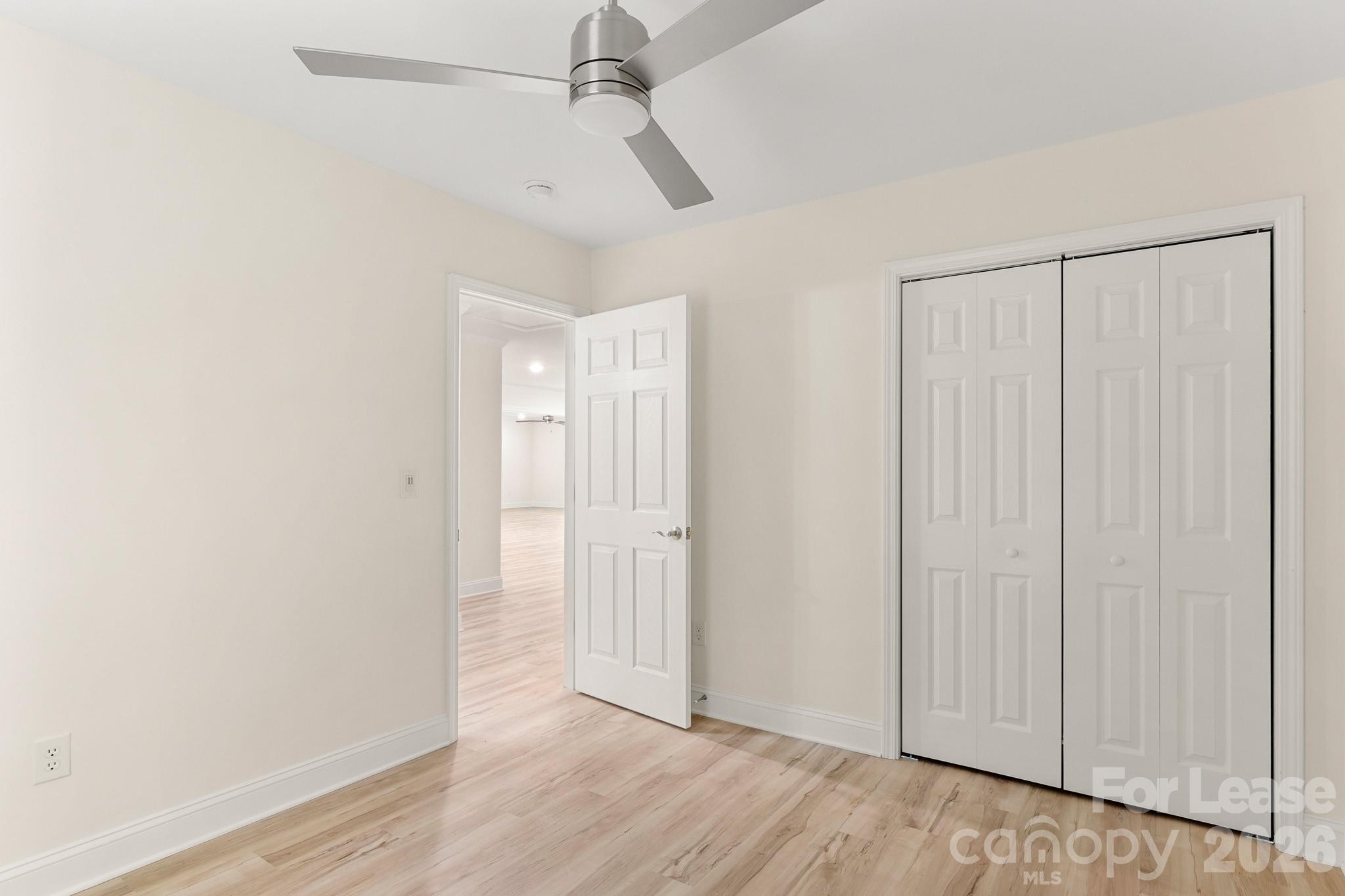 116 Maple Grove Church Road Matthews, NC 28104 - Photo 31 of 41 an empty room with wooden floor closet and windows