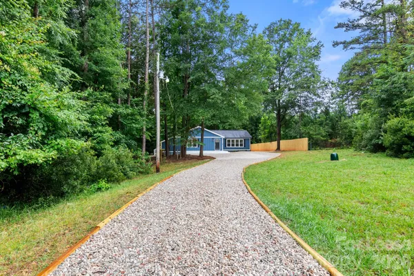 a view of a house with a yard and deck