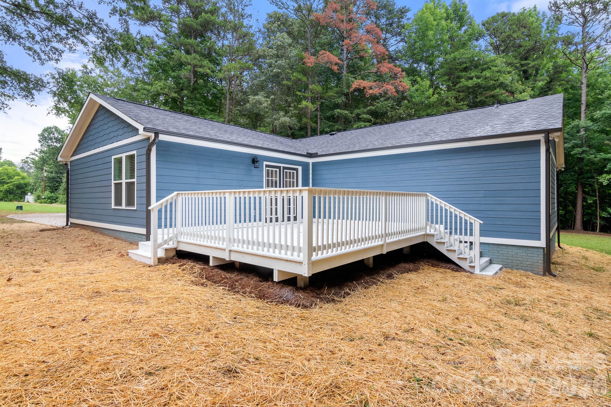 116 Maple Grove Church Road Matthews, NC 28104 - Photo 40 of 41 a view of a house with a yard and deck