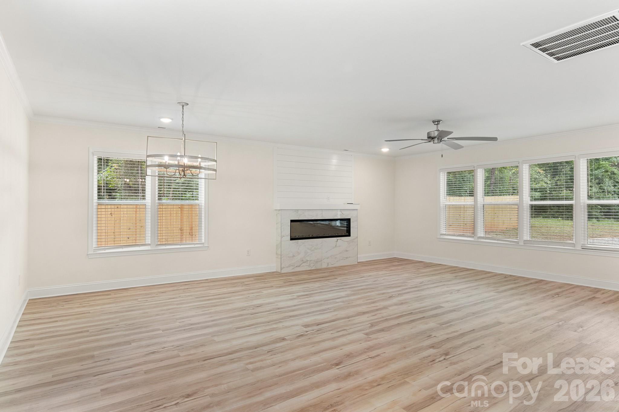 116 Maple Grove Church Road Matthews, NC 28104 - Photo 4 of 41 an empty room with wooden floor and windows