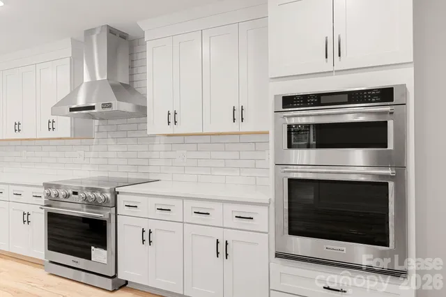 a kitchen with a sink stove and cabinets