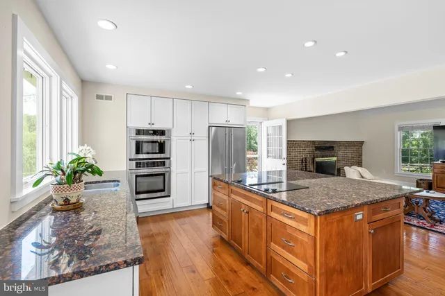 a bedroom with furniture and a large window
