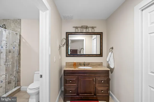 a bathroom with a sink a vanity and a mirror
