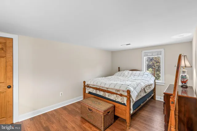 a view of a swimming pool with a garden and trees